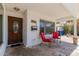 Inviting front porch with red chairs, creating a cozy outdoor seating area at 1017 S San Jose Cir, Mesa, AZ 85202