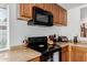 Kitchen featuring wood cabinets, black appliances and tile backsplash at 1017 S San Jose Cir, Mesa, AZ 85202