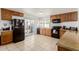 Kitchen with wood cabinets and black appliances, and access to the backyard patio at 1017 S San Jose Cir, Mesa, AZ 85202