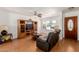 Comfortable living room with a ceiling fan, entertainment center, and leather couch at 1017 S San Jose Cir, Mesa, AZ 85202