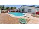 Backyard with a sparkling blue pool with a diving board and a playset, perfect for outdoor fun at 1017 S San Jose Cir, Mesa, AZ 85202