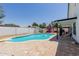 Backyard featuring a sparkling blue pool with a diving board and a playset, perfect for outdoor fun at 1017 S San Jose Cir, Mesa, AZ 85202