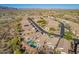 An aerial neighborhood view features houses with private pools, desert landscaping, and mountain views at 10276 E Meandering Trail Ln, Gold Canyon, AZ 85118
