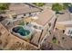 Aerial view of the backyard featuring a kidney-shaped pool, turf area, and desert landscaping at 10276 E Meandering Trail Ln, Gold Canyon, AZ 85118