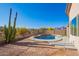 Property featuring a pool with desert landscaping, cactus accents, and mountain views at 10276 E Meandering Trail Ln, Gold Canyon, AZ 85118