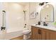 Bathroom with wood-styled vanity, modern fixtures, and shower-tub combo at 10276 E Meandering Trail Ln, Gold Canyon, AZ 85118