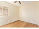 Bright bedroom with woodgrain floors, neutral walls, and a modern ceiling fan at 10276 E Meandering Trail Ln, Gold Canyon, AZ 85118