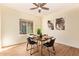 Bright dining room features a ceiling fan, wood floors, modern decor, and an abundance of natural light at 10276 E Meandering Trail Ln, Gold Canyon, AZ 85118