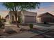 Single Gathering home with a two-car garage featuring desert landscaping in front at 10276 E Meandering Trail Ln, Gold Canyon, AZ 85118