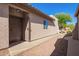 Exterior view of the front door with a 'hello' welcome mat and desert landscaping at 10276 E Meandering Trail Ln, Gold Canyon, AZ 85118