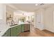 This kitchen has green cabinets, stainless appliances, white countertops, and views to the living space at 10276 E Meandering Trail Ln, Gold Canyon, AZ 85118