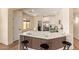 The kitchen has stylish wood accents on the breakfast bar, stainless appliances, and white countertops at 10276 E Meandering Trail Ln, Gold Canyon, AZ 85118