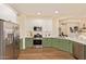 This kitchen features green lower cabinets, white uppers, stainless appliances, and white countertops at 10276 E Meandering Trail Ln, Gold Canyon, AZ 85118