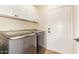 Well-equipped laundry room with a modern washer and dryer, and ample cabinet space at 10276 E Meandering Trail Ln, Gold Canyon, AZ 85118