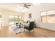 Bright living room with skylight, wood floors, and sliding glass doors to the backyard at 10276 E Meandering Trail Ln, Gold Canyon, AZ 85118