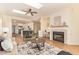 Open-concept living room featuring a fireplace, skylight, and seamless flow to the kitchen at 10276 E Meandering Trail Ln, Gold Canyon, AZ 85118