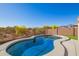 Relaxing backyard pool with mountain views offers a great desert oasis under a bright blue sky at 10276 E Meandering Trail Ln, Gold Canyon, AZ 85118