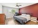 Bedroom featuring a cozy bed, functional desk area, and a calming atmosphere at 10921 W Santa Fe Dr, Sun City, AZ 85351