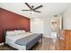 Bedroom featuring a comfortable bed, ceiling fan, and convenient access to the outdoors at 10921 W Santa Fe Dr, Sun City, AZ 85351