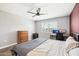 Bedroom with neutral tones, ceiling fan, and ample natural light from a bright window at 10921 W Santa Fe Dr, Sun City, AZ 85351