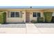 Inviting front entrance with security door, manicured shrubbery and gravel landscaping at 10921 W Santa Fe Dr, Sun City, AZ 85351
