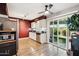 Bright kitchen with stainless steel appliances, granite counters, and sliding glass doors at 10921 W Santa Fe Dr, Sun City, AZ 85351