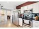 Kitchen showcasing stainless steel appliances, including microwave and oven, with stylish tile backsplash at 10921 W Santa Fe Dr, Sun City, AZ 85351