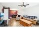 Open living and dining area featuring a ceiling fan and wood-look floors at 10921 W Santa Fe Dr, Sun City, AZ 85351