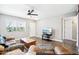 Comfortable living room with ceiling fan and wood-look floors at 10921 W Santa Fe Dr, Sun City, AZ 85351