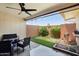 Inviting patio featuring stylish seating, a well-maintained grill, and artificial grass at 10921 W Santa Fe Dr, Sun City, AZ 85351
