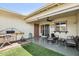 Outdoor patio showcasing comfortable seating, a grill, and a pleasant backyard at 10921 W Santa Fe Dr, Sun City, AZ 85351