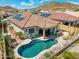 Aerial view of pool, yard, outdoor kitchen and solar panels at 12027 S 183Rd Dr, Goodyear, AZ 85338