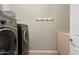The well-equipped laundry room features modern washer and dryer at 12027 S 183Rd Dr, Goodyear, AZ 85338