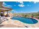 Inviting pool with desert landscaping, privacy fence and covered patio, offering a tranquil outdoor retreat at 12027 S 183Rd Dr, Goodyear, AZ 85338