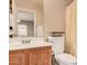 Well-maintained bathroom featuring a vanity, toilet, mirror, and shower with decorative curtain at 12034 W Aster Dr, El Mirage, AZ 85335