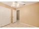 Bedroom with tile flooring and large closet shows a bright doorway with access to other parts of the house at 12034 W Aster Dr, El Mirage, AZ 85335