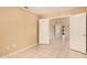 Large bedroom showcasing tile flooring and two doorways that create an open and accessible layout at 12034 W Aster Dr, El Mirage, AZ 85335