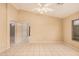 Spacious living room featuring tile flooring, a ceiling fan, and lots of natural light at 12034 W Aster Dr, El Mirage, AZ 85335