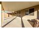 Covered patio area with block wall fence and access door at 12034 W Aster Dr, El Mirage, AZ 85335