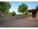 Private backyard with a block fence, gravel landscaping, and a covered patio at 1220 S Wagon Wheel Dr, Chandler, AZ 85286