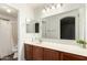 Bright bathroom featuring a modern vanity with a large mirror and neutral color palette at 1220 S Wagon Wheel Dr, Chandler, AZ 85286