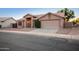Inviting single-story home features a well-manicured yard and a spacious two-car garage at 1220 S Wagon Wheel Dr, Chandler, AZ 85286