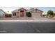Charming single-story home with a well-maintained front yard and two car garage at 1220 S Wagon Wheel Dr, Chandler, AZ 85286