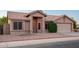 Beautiful exterior of home with neutral stucco, tile roof, well maintained yard, and inviting entrance at 1220 S Wagon Wheel Dr, Chandler, AZ 85286