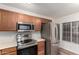 Well-equipped kitchen featuring stainless steel appliances, plentiful counter space, and wood cabinets at 1220 S Wagon Wheel Dr, Chandler, AZ 85286