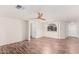 Open-concept living room boasting wood-look flooring, arched doorway, and lots of natural light at 1220 S Wagon Wheel Dr, Chandler, AZ 85286