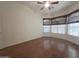 Bedroom featuring wood floors, natural light from the windows with stylish shades and a ceiling fan at 1248 W Deoni Trl, San Tan Valley, AZ 85143