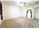 Bedroom with ceiling fan, carpet and arched doorway at 1248 W Deoni Trl, San Tan Valley, AZ 85143