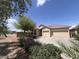 Attractive home with desert landscaping, a tile roof, and a spacious three car driveway at 1248 W Deoni Trl, San Tan Valley, AZ 85143
