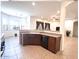 Kitchen with granite countertops and bar seating to living space at 1248 W Deoni Trl, San Tan Valley, AZ 85143